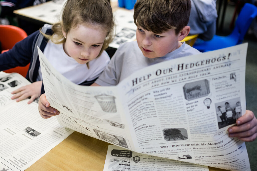 Children receive their newspapers